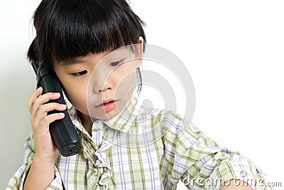 Child speaking on the phone Stock Photo