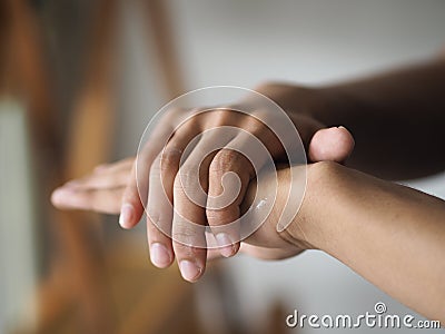 Child is standing with the finger to rub the gel alcoholic 70 percent mixture with gelatin on the back of the hand to prevent Stock Photo