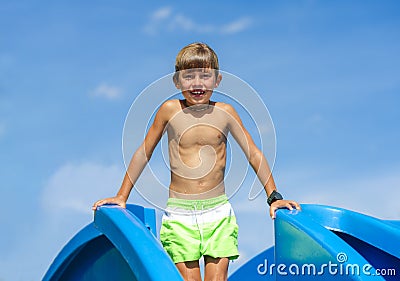 Child standing on a pool slide Stock Photo