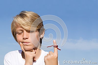 Child with string tied reminder Stock Photo