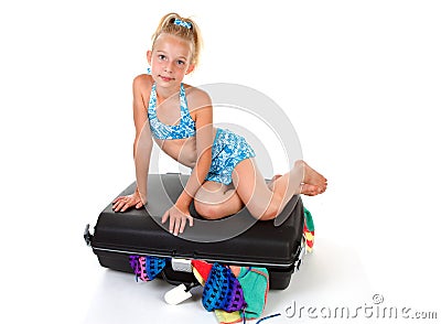 Child on stuffed suitcase Stock Photo