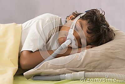 Child suffering from Sleep Apnea, wearing a respiratory mask Stock Photo