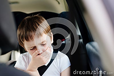 Child suffers from motion sickness in car Stock Photo