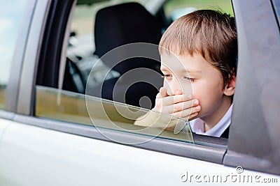 Child suffers from motion sickness in car Stock Photo