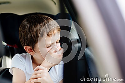 Child suffers from motion sickness in car Stock Photo