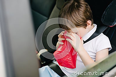 Child suffers from motion sickness in car Stock Photo