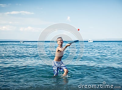 Child in swimware playing in sea Stock Photo