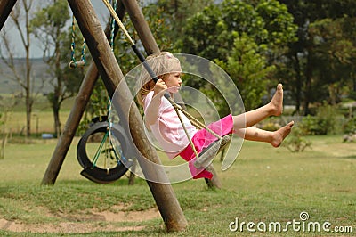 Child on swing Stock Photo