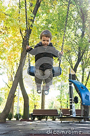 Child swinging in the park Stock Photo