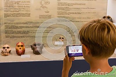 Child taking skull primate photography at museum Stock Photo