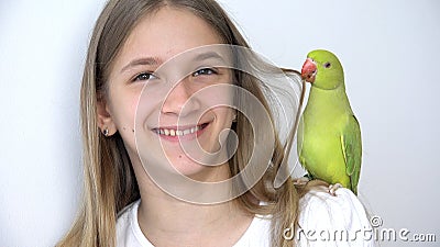 Child Talk Parrot, Happy Kid Playing her Pet, Girl Plays Bird at Home, Funny Indian Ring-Necked Parakeet Birds Cage Family Stock Photo