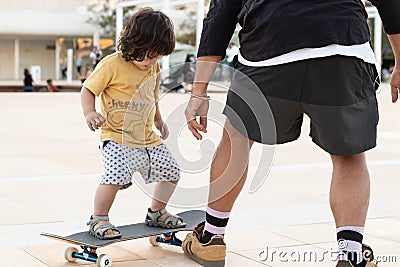 Child and teacher learning to skate Stock Photo