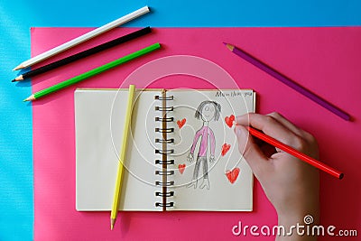 Child - teenager draws a picture for mom Stock Photo