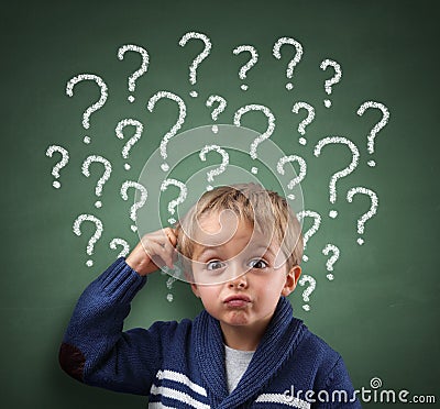 Child thinking with question mark on blackboard Stock Photo