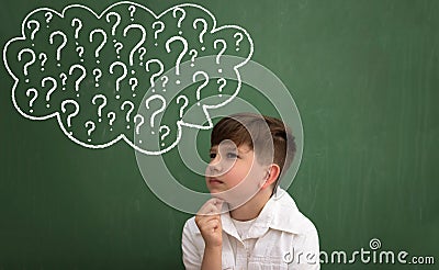 Child thinking with a thought bubble of question marks Stock Photo