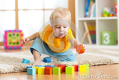 Child toddler playing wooden toys at home Stock Photo