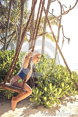 Child toddler swing beach during summer vacation concept happy childhood travel lifestyle Stock Photo