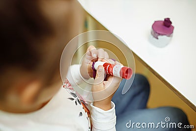 A child in training at home during quarantine makes origami out of paper. children`s creativity. hands close up Stock Photo