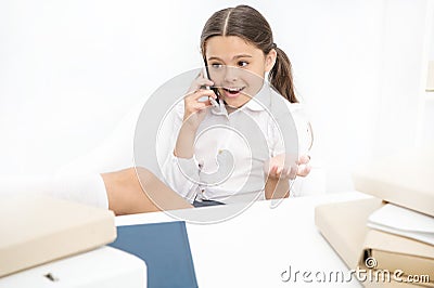 Child use smartphone mobile to communicate in school. Fresh school gossip. She like talking too much. Discussing rumors Stock Photo