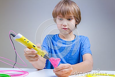 Child using 3D printing pen. Boy making heart. Creative, technology, leisure, education concept Stock Photo