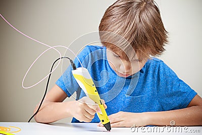 Child using 3D printing pen. Boy making new item. Creative, technology, leisure, education concept Stock Photo