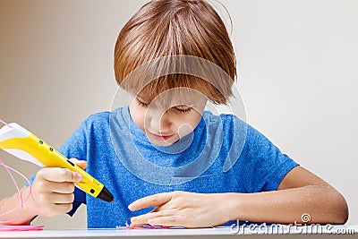 Child using 3D printing pen. Boy making new item. Creative, technology, leisure, education concept Stock Photo