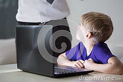 Child using father's laptop Stock Photo