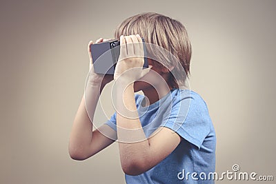 Child using Virtual Reality VR cardboard glasses Stock Photo