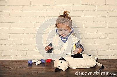 Child veterinarian cure toy animal with vaccine Stock Photo