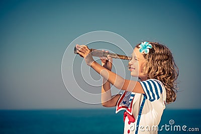 Child with vintage spyglass on summer vacation Stock Photo