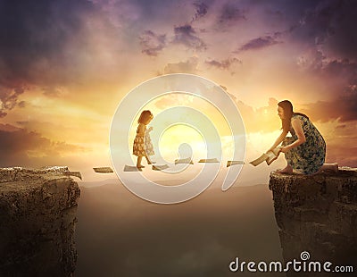 Child walking on pages over cliff Stock Photo