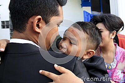 A child was crying in his uncle`s lap Editorial Stock Photo