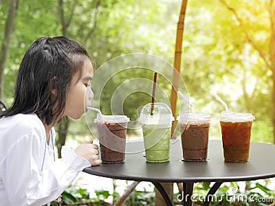 Child was drinking refershment water with green background Stock Photo