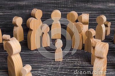 The child was lost in the crowd. A crowd of wooden figures of people surround a lost child. Lost kid Stock Photo