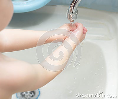 A child washes his hands with soap in the bathroom. The concept of hygiene and clean hands, infection, close-up, soundness, Stock Photo