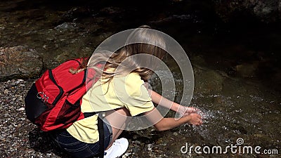 Child Washing Hands in River Water, Kid Hiking at Camping in Mountains Trails, Teenager Girl Walking in Forest, Adventure Trip Stock Photo