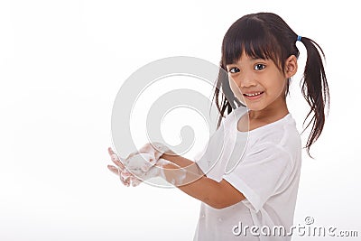 Child washing hands and showing soapy palms. Stock Photo