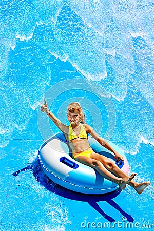 Child on water slide at aquapark. Stock Photo