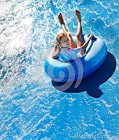 Child on water slide at aquapark. Stock Photo