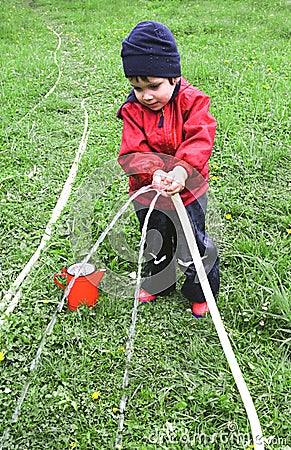 Child watering the garden Stock Photo