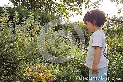 Child watering garden Stock Photo