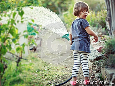 Child watering garden Stock Photo