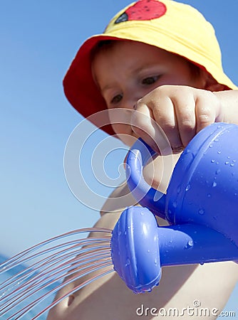 Child and watering-pot Stock Photo