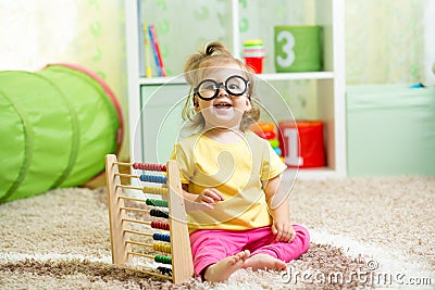 Child weared glasses playing with abacus Stock Photo