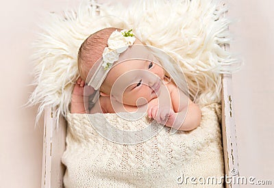 Child wearing a hairband in baby basket, closeup Stock Photo