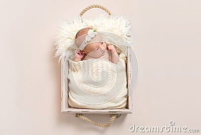 Child wearing a hairband in baby basket, closeup Stock Photo