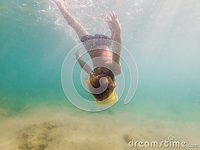 Child wearing snorkeling mask diving underwater Stock Photo