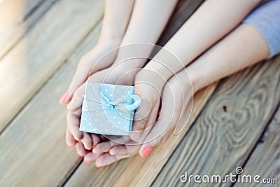 Child and woman holding small gift box Stock Photo