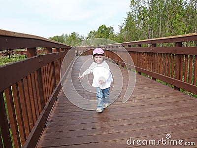 Child on wooden walkway Stock Photo