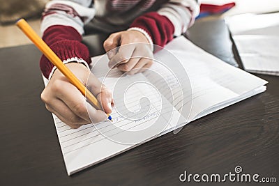 Child write in a notebook. Stock Photo